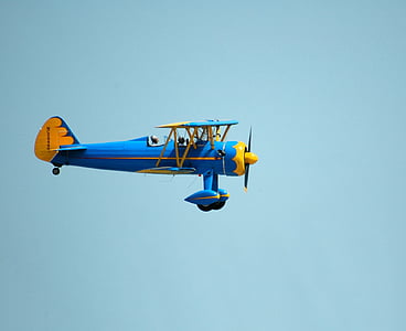 closeup photo of blue and yellow plane