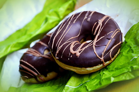 shallow focus photography of two chocolate doughnuts