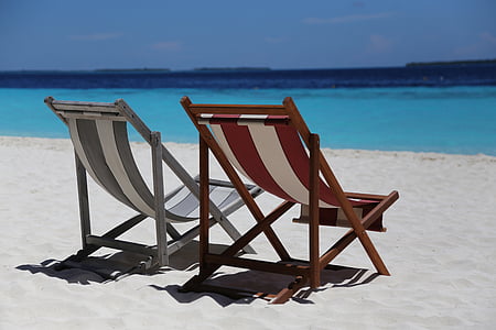 two brown and grey striped loungers beside beach during daytime
