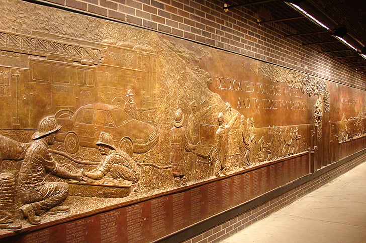 brown wooden wall with sculptures