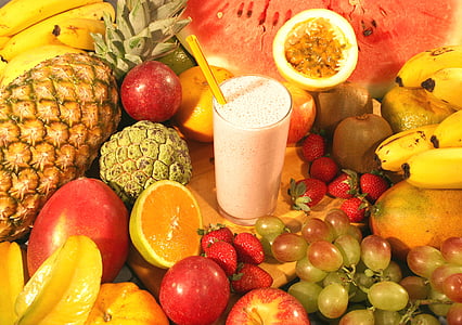 milk drink surrounded by assorted fruits