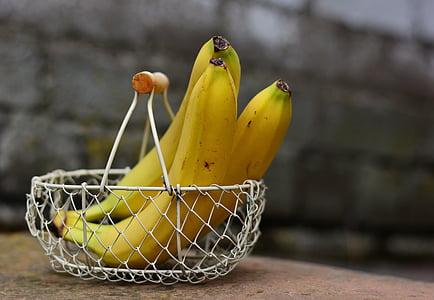 three ripe bananas on basket