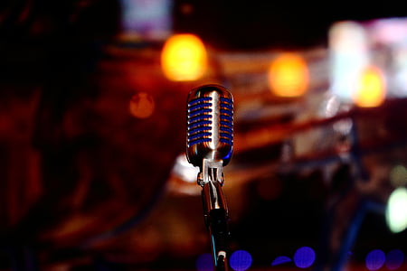 selective focus photography of black condenser microphone