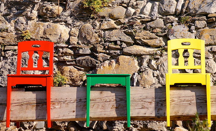 red, green, and yellow wooden chairs