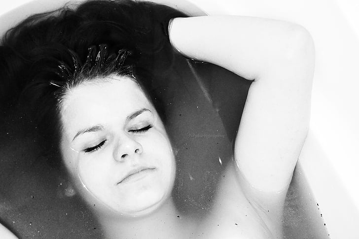 grayscale photo of woman in bathtub