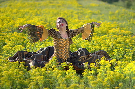 woman standing on green grass field