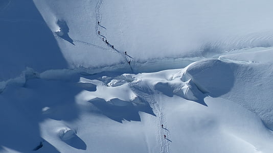 aerial photography of people walking on snowy terrain