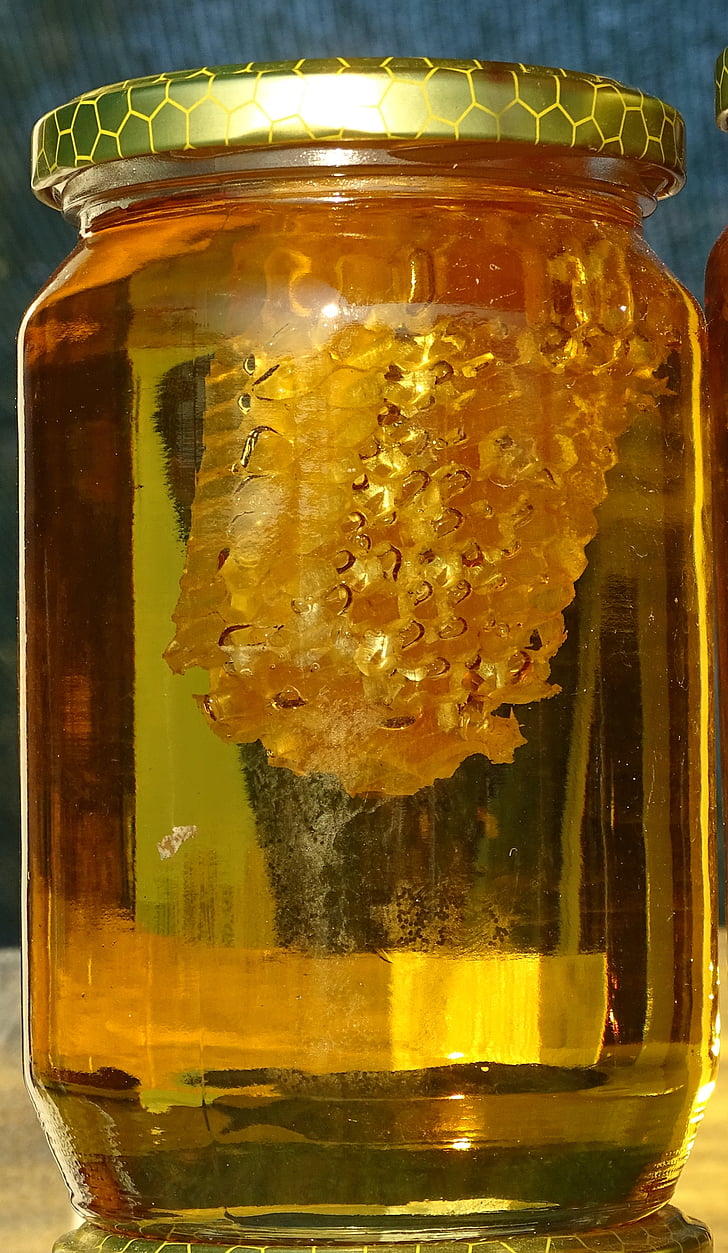 clear glass jar containing honey