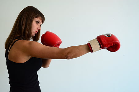 woman wearing red boxing gloves inside room