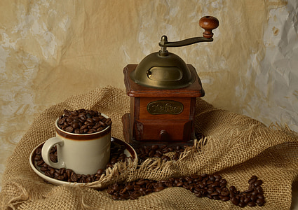brown coffee grinder and white ceramic mug