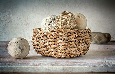 basket of ball ornaments inside wicker brown basket